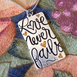 NWOT "LOVE NEVER FAILS" Silvertone Pendant necklace!